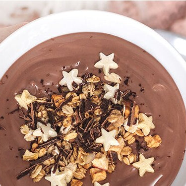 Selbstgemachter Schokoladenpudding in einer Schüssel mit Christmas-Granola