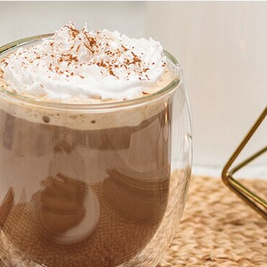 Gingerbread Latte mit einem Teelicht daneben