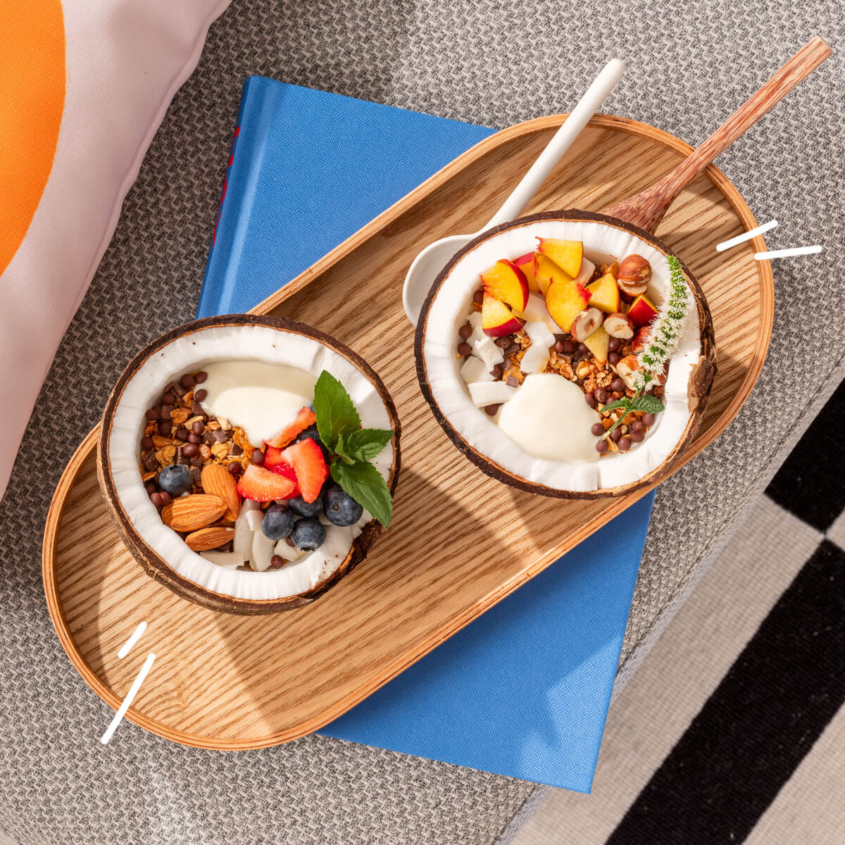 Vegane mymuesli Müslis in Kokosnüssen mit frischen Beeren, Früchten, Nüssen und Joghurt